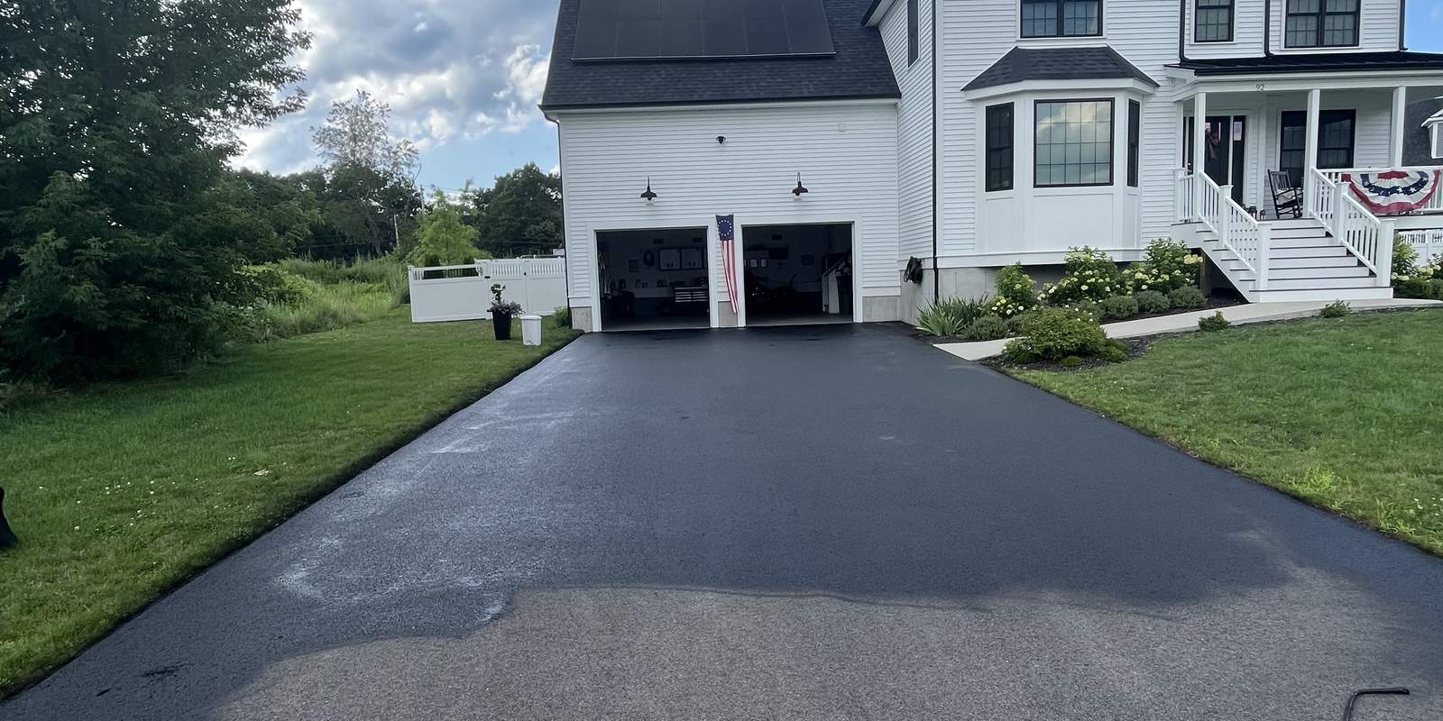 Established asphalt driveway at a New England farmhouse