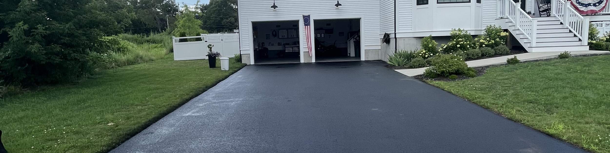 Freshly paved asphalt driveway at a South Shore home