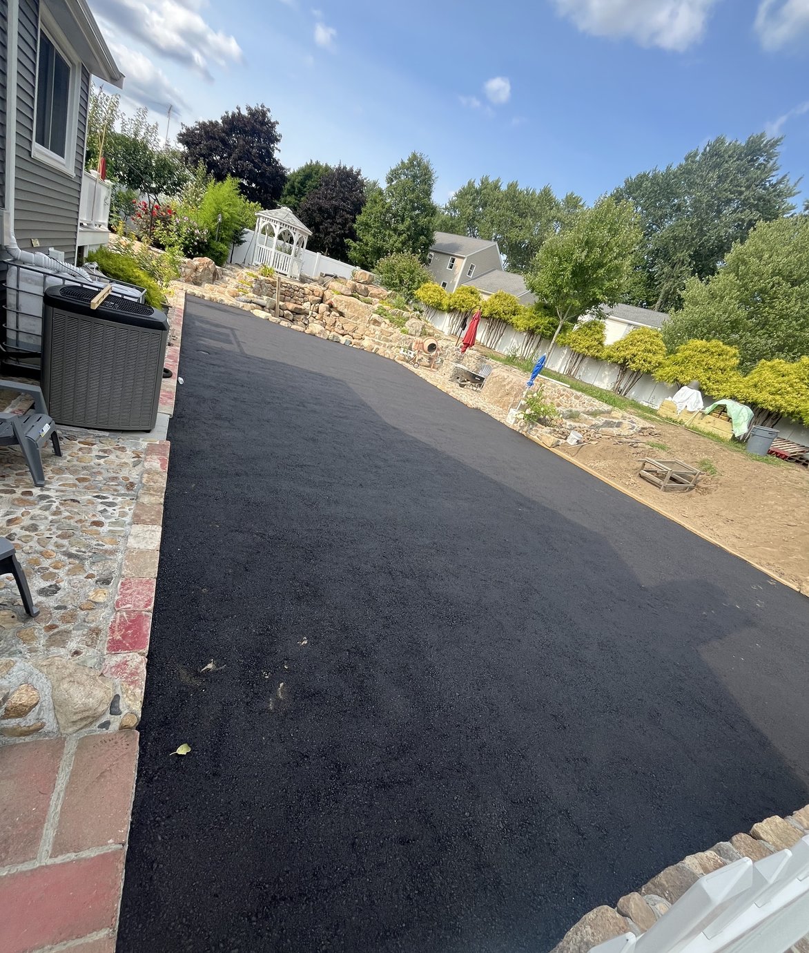 freshly paved walkway with stone edging