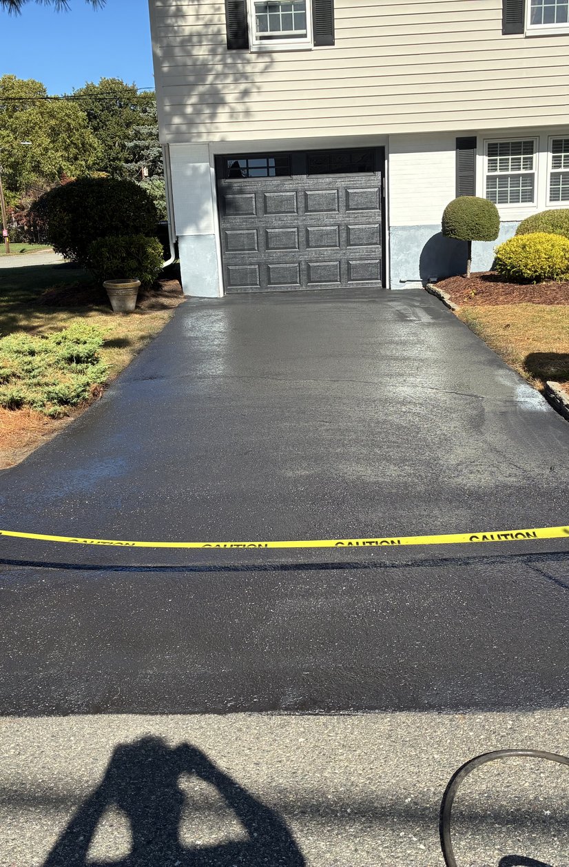 sealcoated driveway with landscaping