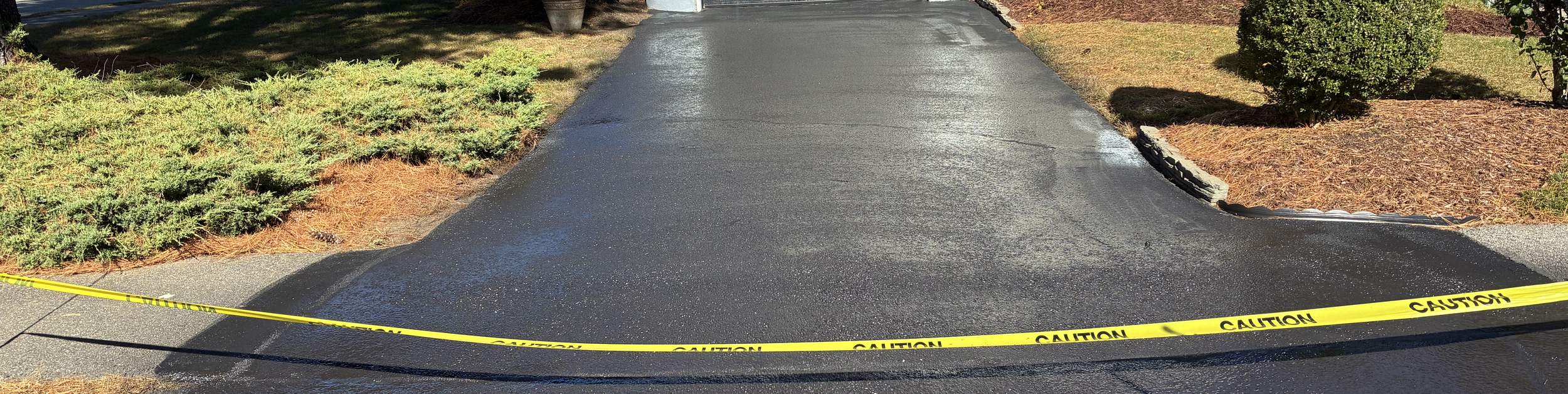 Freshly sealcoated asphalt driveway