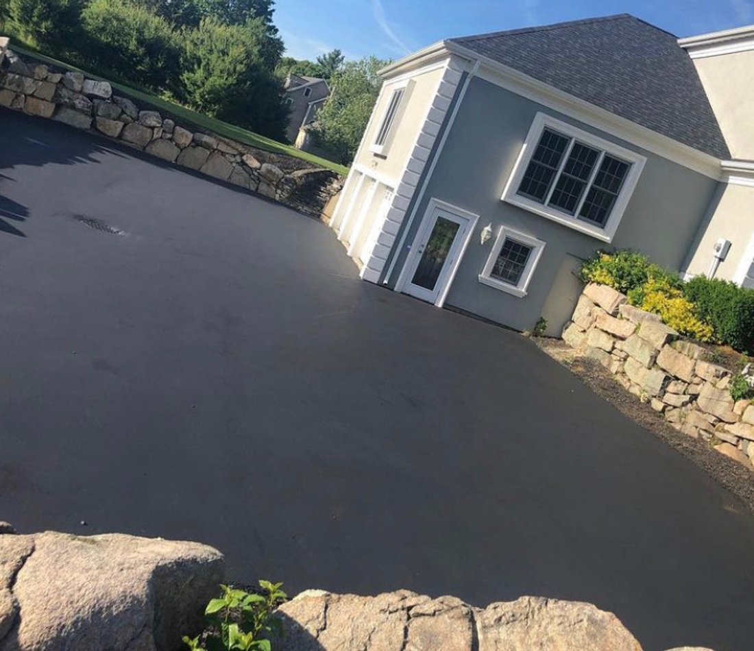driveway alongside stone wall