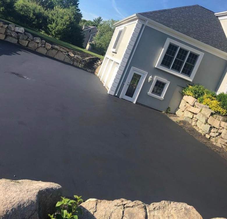 sloped driveway with stone retaining walls