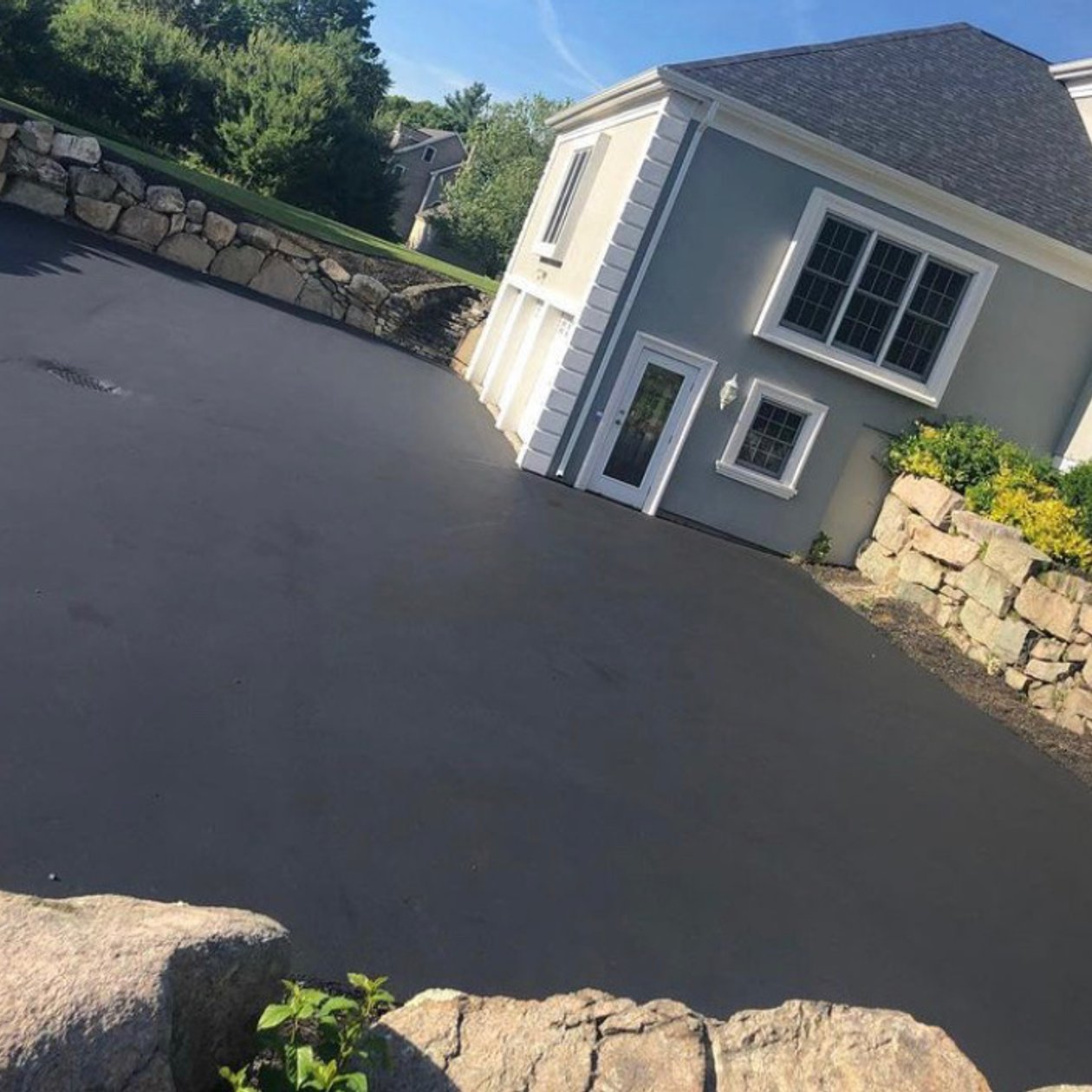 sloped driveway with stone retaining walls