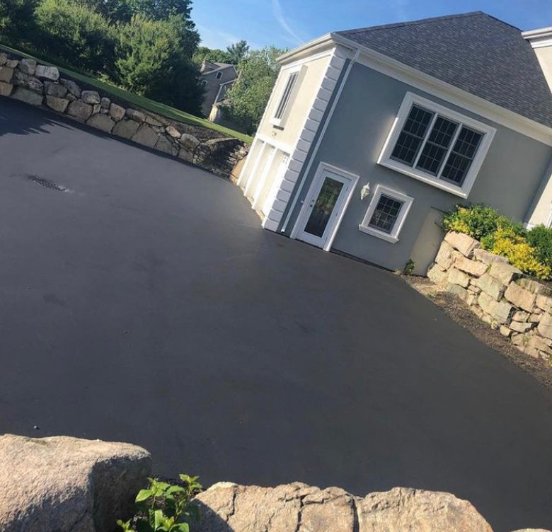 sloped driveway with stone retaining walls