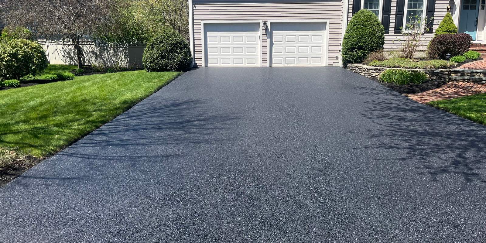 Asphalt driveway at a three-car garage on the South Shore