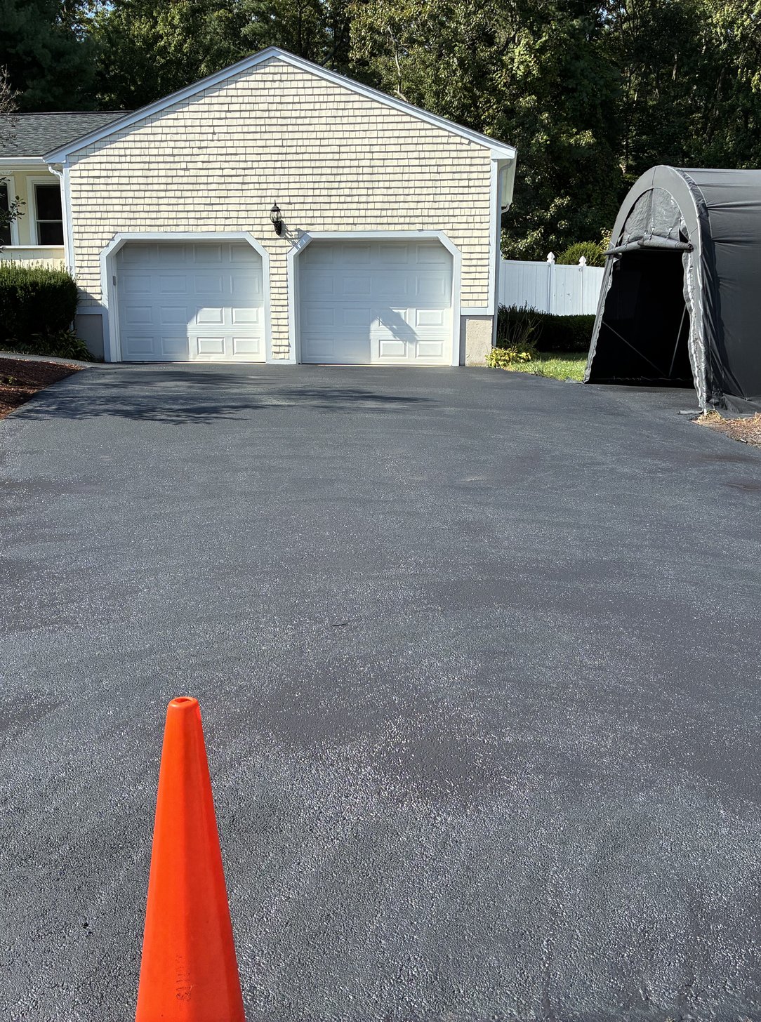 freshly paved two-car garage driveway
